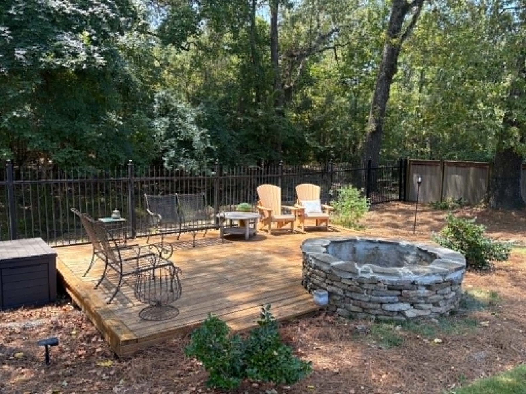 Finished deck and stacked stone fire pit built by Oakvera Outdoor Living near Madison, MS