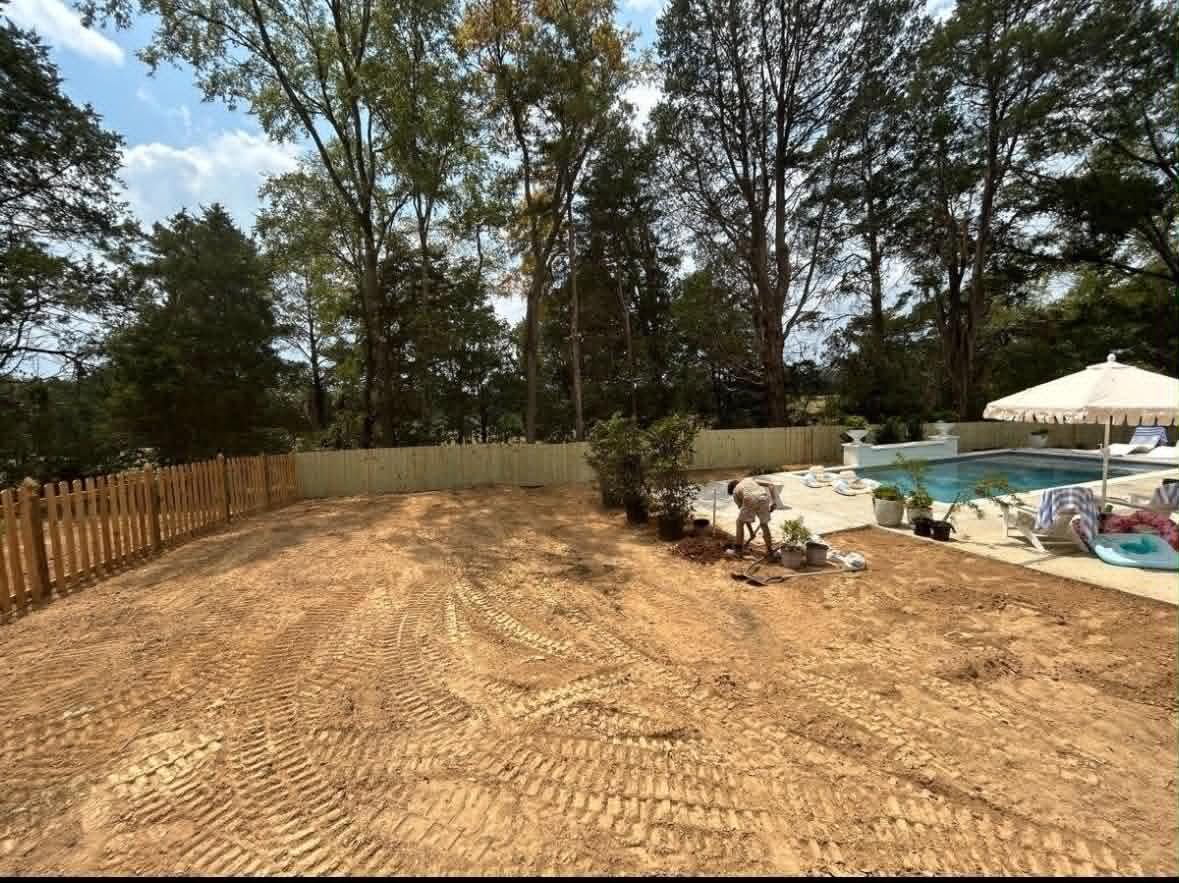 Before: poolside backyard stripped and graded flat ahead of sod installation in Madison MS